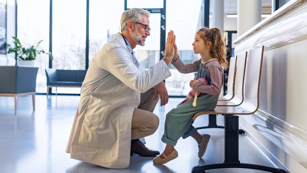 Doctor high-fiving young patient